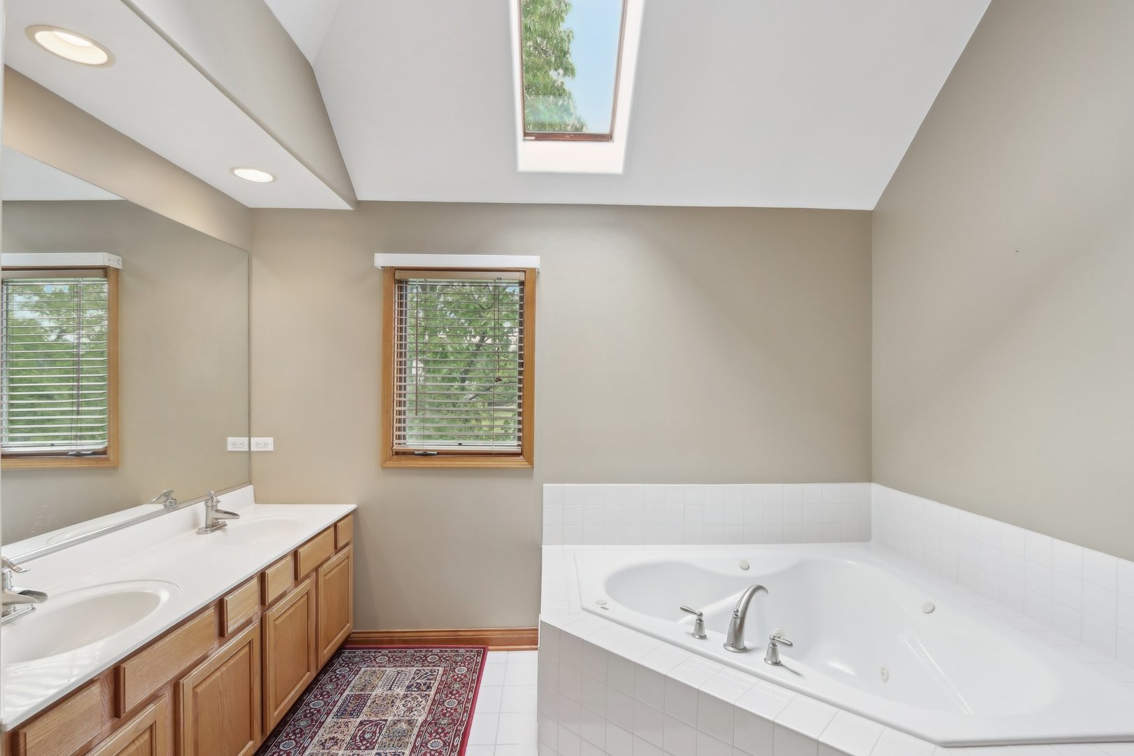 548 Asbury Drive Aurora, IL 60502 - Photo 28 of 48 a bathroom with a tub sink and mirror