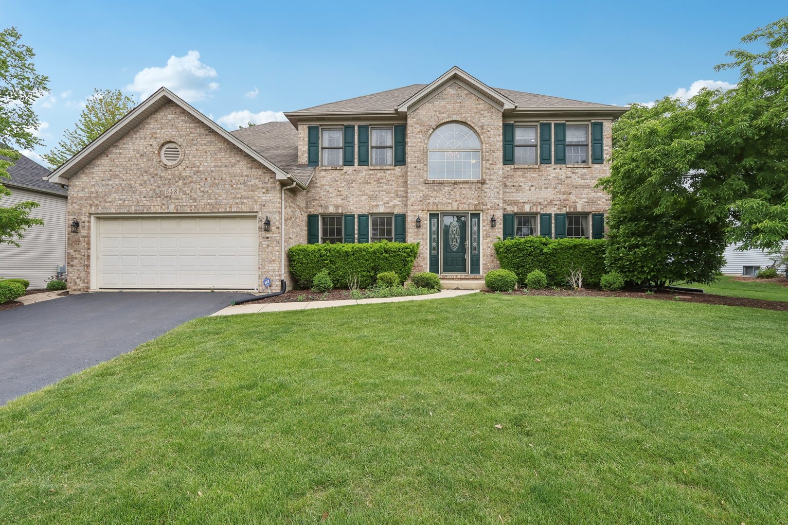 548 Asbury Drive Aurora, IL 60502 - Photo 47 of 48 a front view of a house with garden