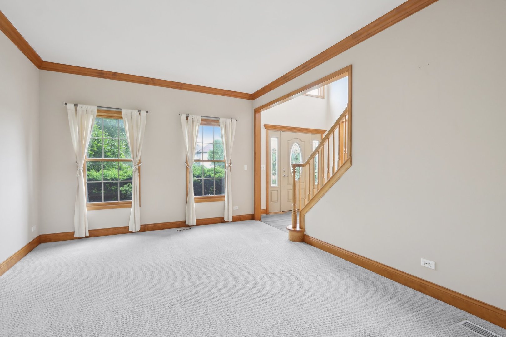 548 Asbury Drive Aurora, IL 60502 - Photo 6 of 48 a view of an empty room with wooden floor and a window