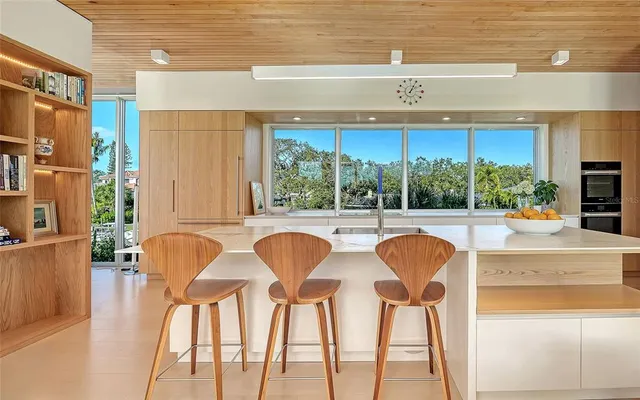 a view of a patio with couches chairs and wooden floor