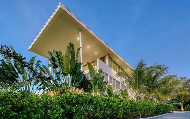 a view of a house with a backyard and a tree