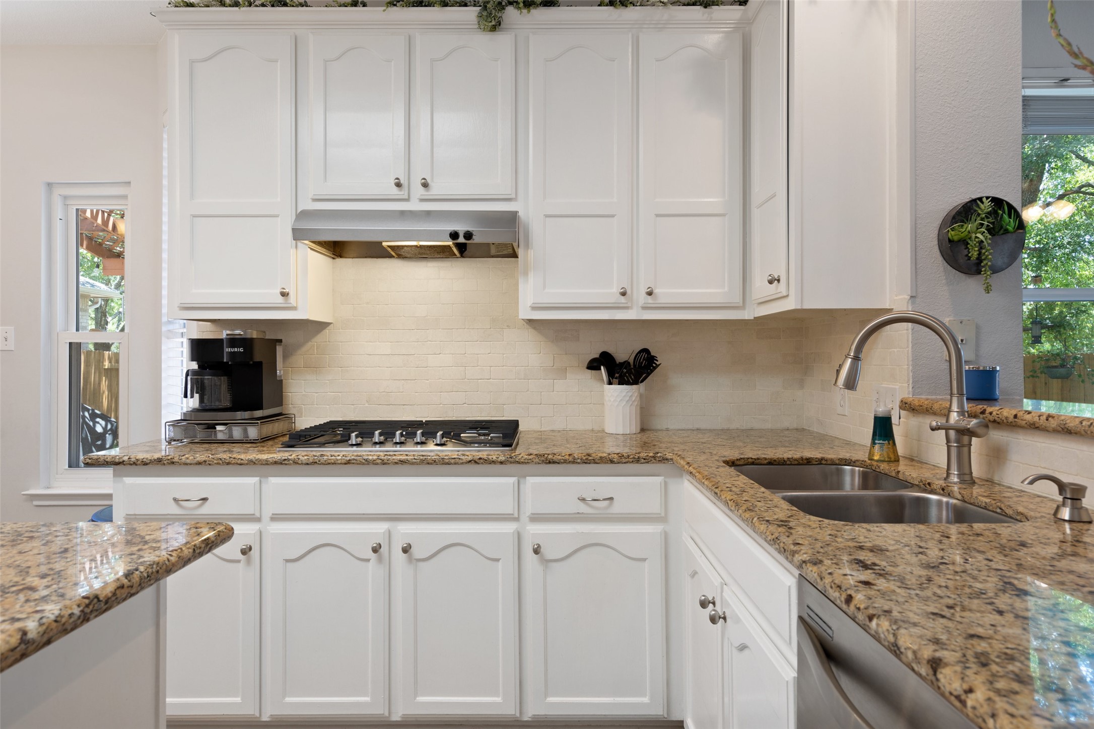 12813 Withers Way Austin, TX 78727 - Photo 11 of 40 a kitchen with granite countertop white cabinets and a sink