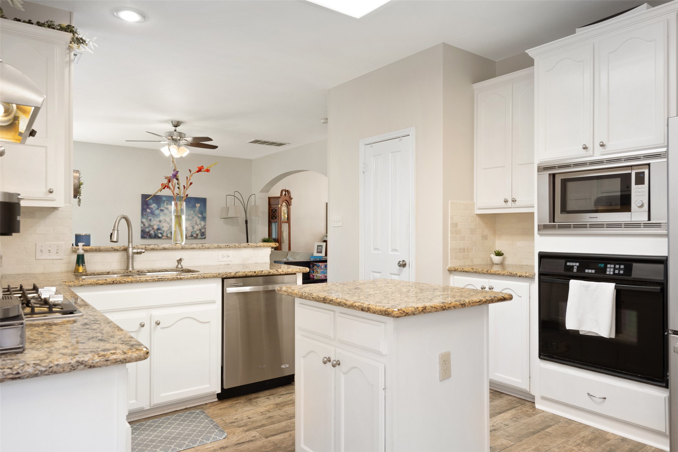 12813 Withers Way Austin, TX 78727 - Photo 12 of 40 a kitchen with granite countertop a sink stove and cabinets
