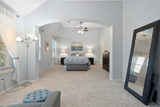 a living room with furniture and a large mirror