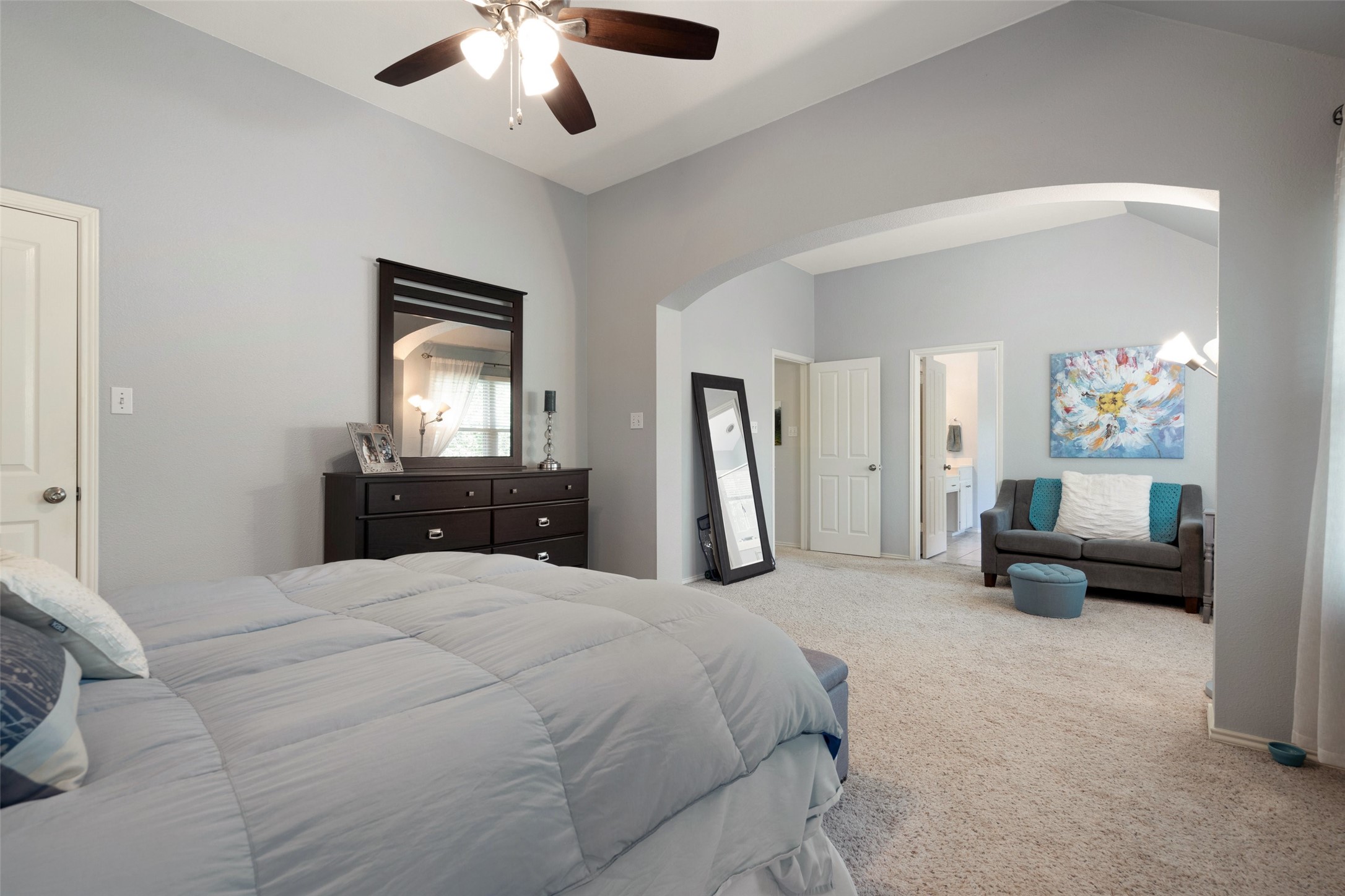 12813 Withers Way Austin, TX 78727 - Photo 20 of 40 a spacious bedroom with a bed and a chandelier