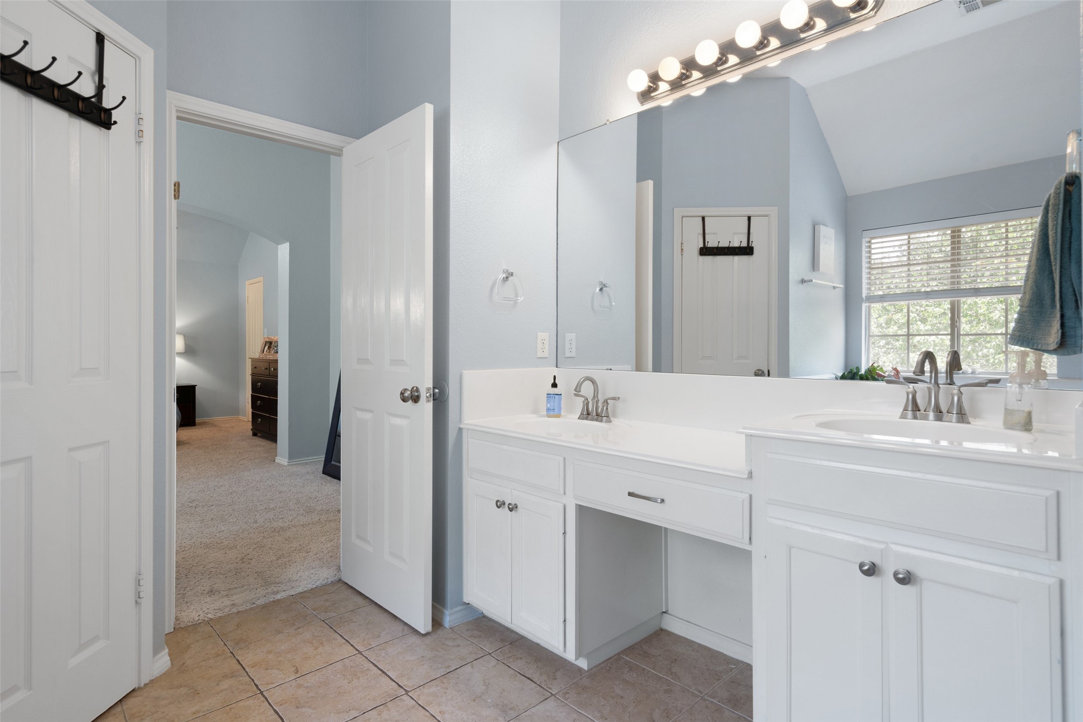 12813 Withers Way Austin, TX 78727 - Photo 21 of 40 a spacious bathroom with a double vanity sink mirror and next to a window