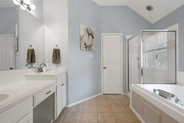 a bathroom with a tub sink and mirror