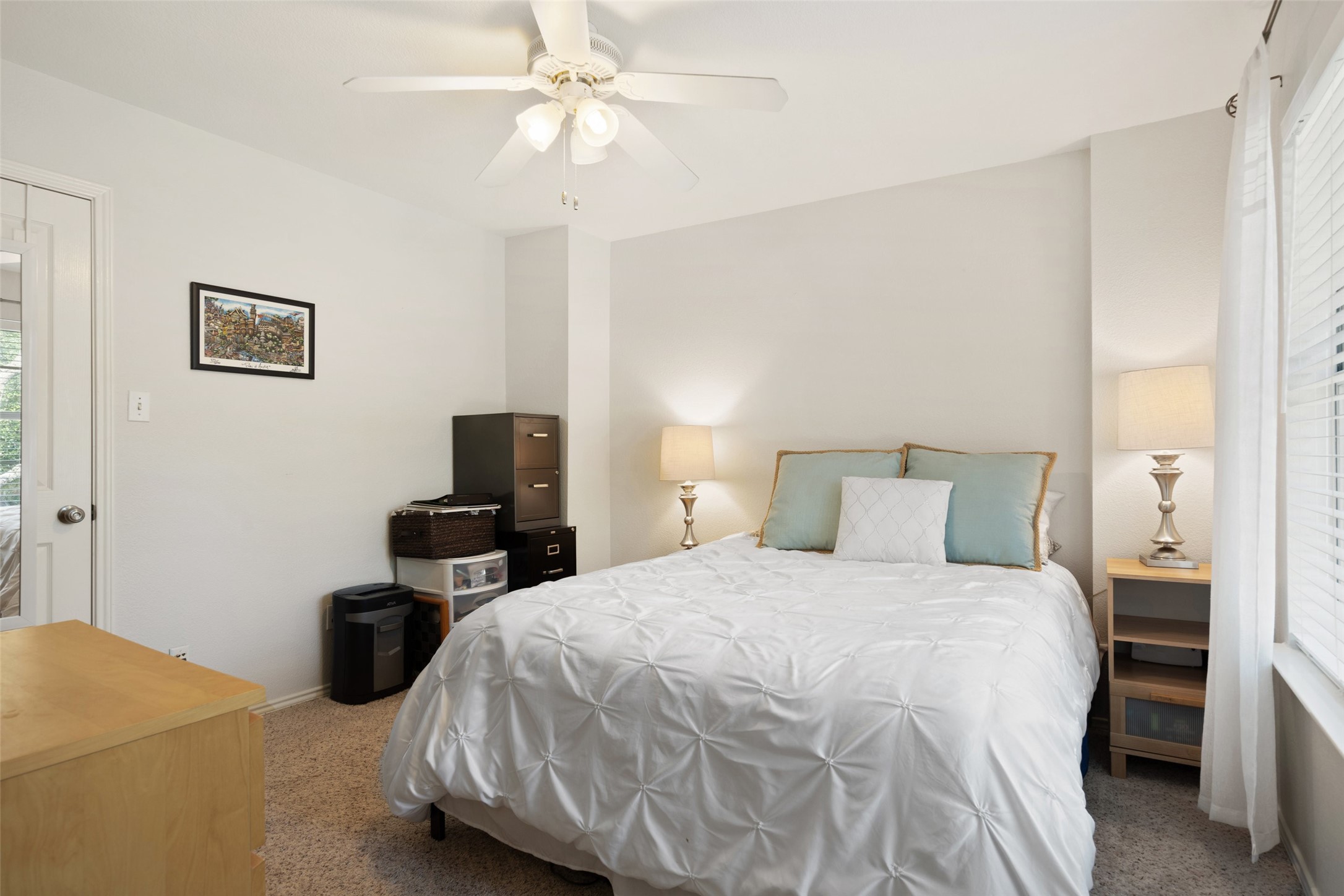12813 Withers Way Austin, TX 78727 - Photo 24 of 40 a bedroom with a bed and a chandelier