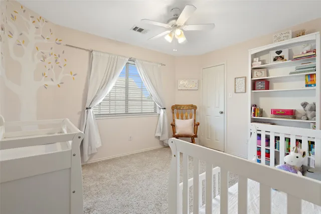 a view of an empty room with a window and shelf