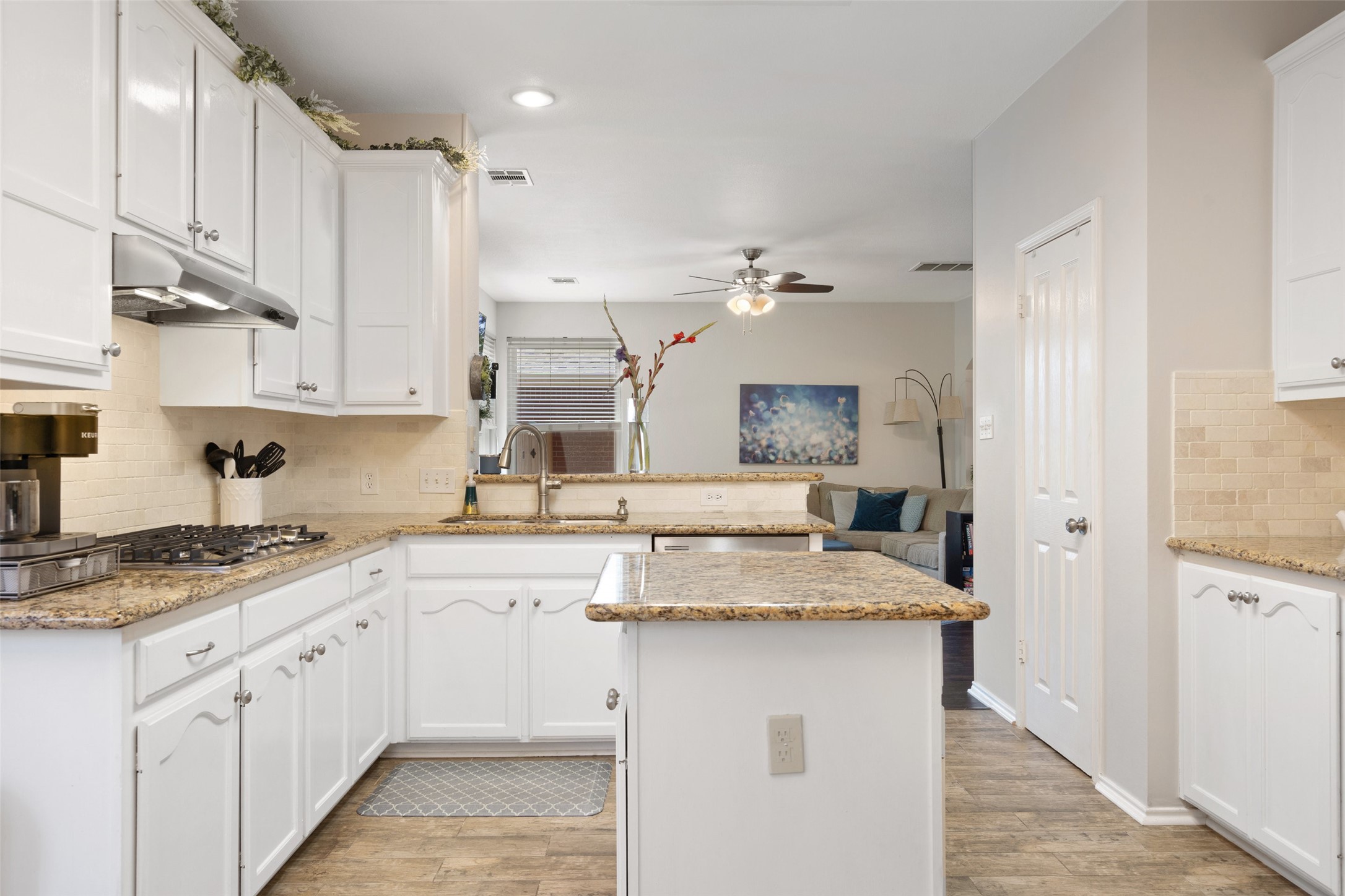 12813 Withers Way Austin, TX 78727 - Photo 3 of 40 a kitchen with a sink dishwasher and white cabinets