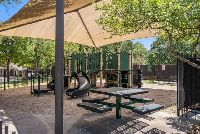 a view of a patio with a dining table and chairs