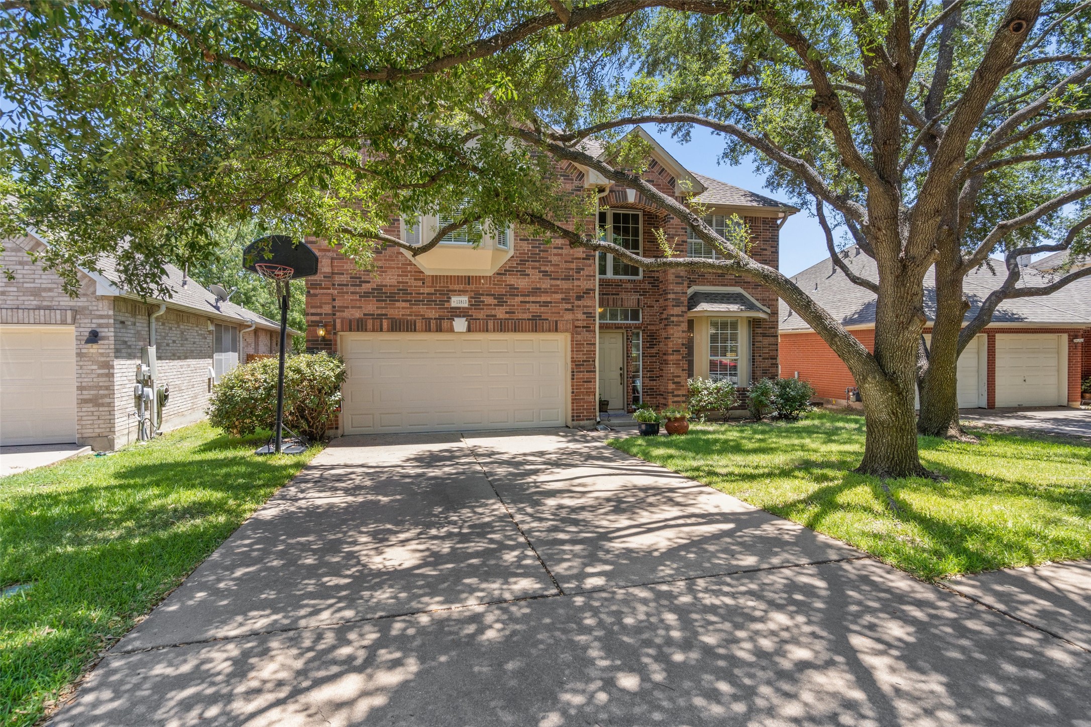 12813 Withers Way Austin, TX 78727 - Photo 5 of 40 a front view of a house with a garden and trees