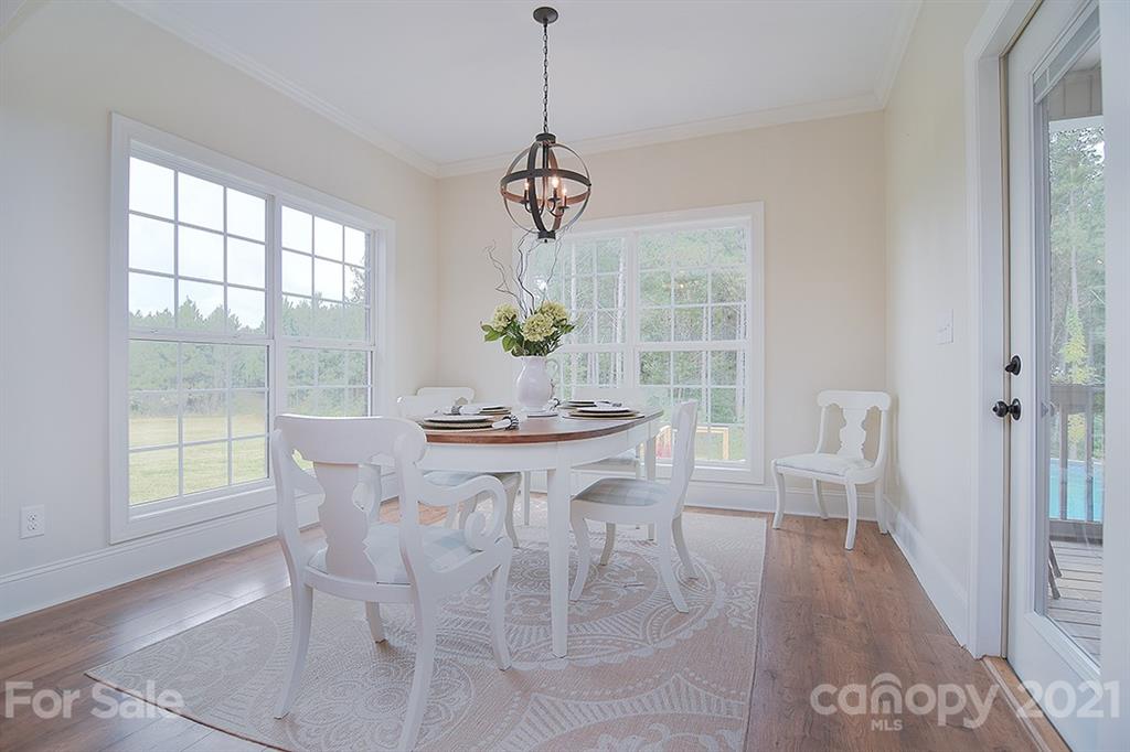5813 Dudley Road Monroe, NC 28112 - Photo 15 of 44 a view of a dining room with furniture window and wooden floor
