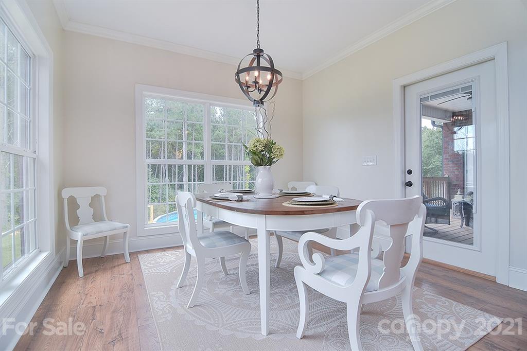 5813 Dudley Road Monroe, NC 28112 - Photo 16 of 44 a view of a dining room with furniture window and wooden floor