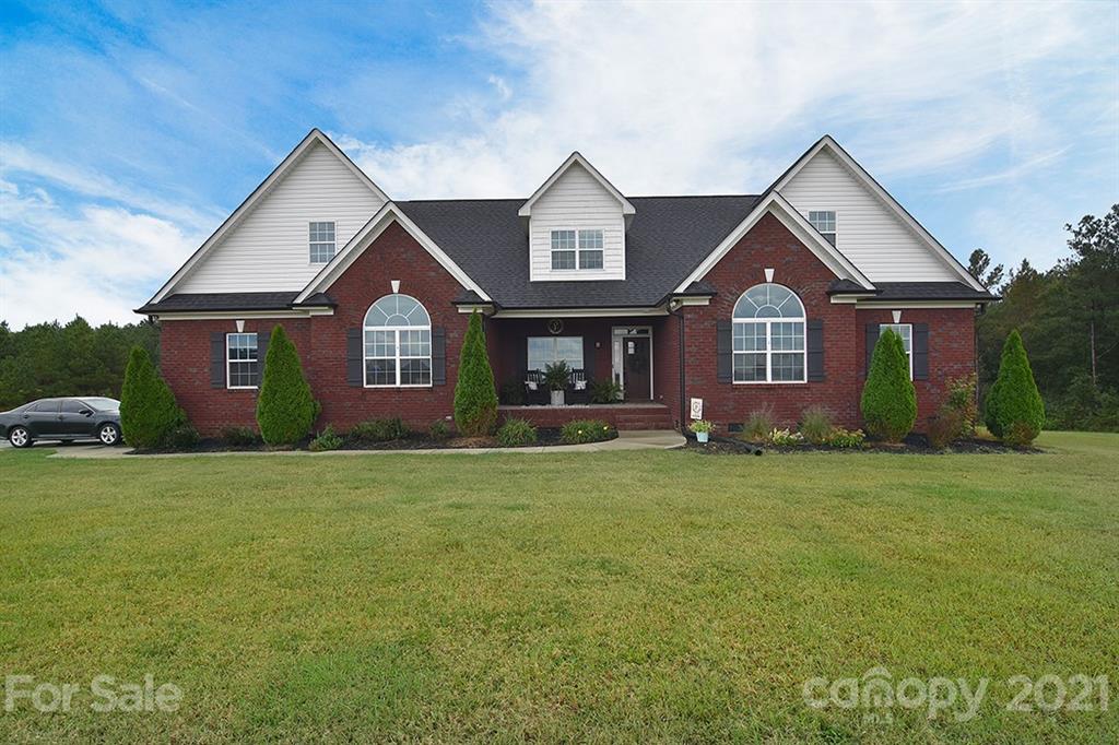 5813 Dudley Road Monroe, NC 28112 - Photo 2 of 44 a front view of a house with a garden and porch