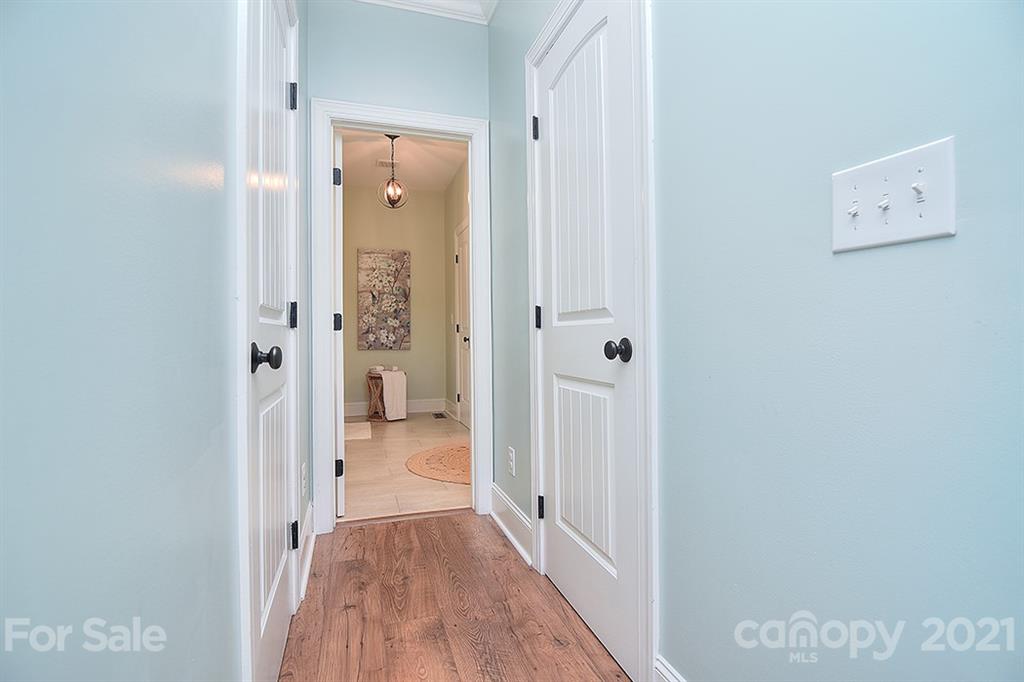 5813 Dudley Road Monroe, NC 28112 - Photo 23 of 44 a view of a hallway with wooden floor and a bathroom