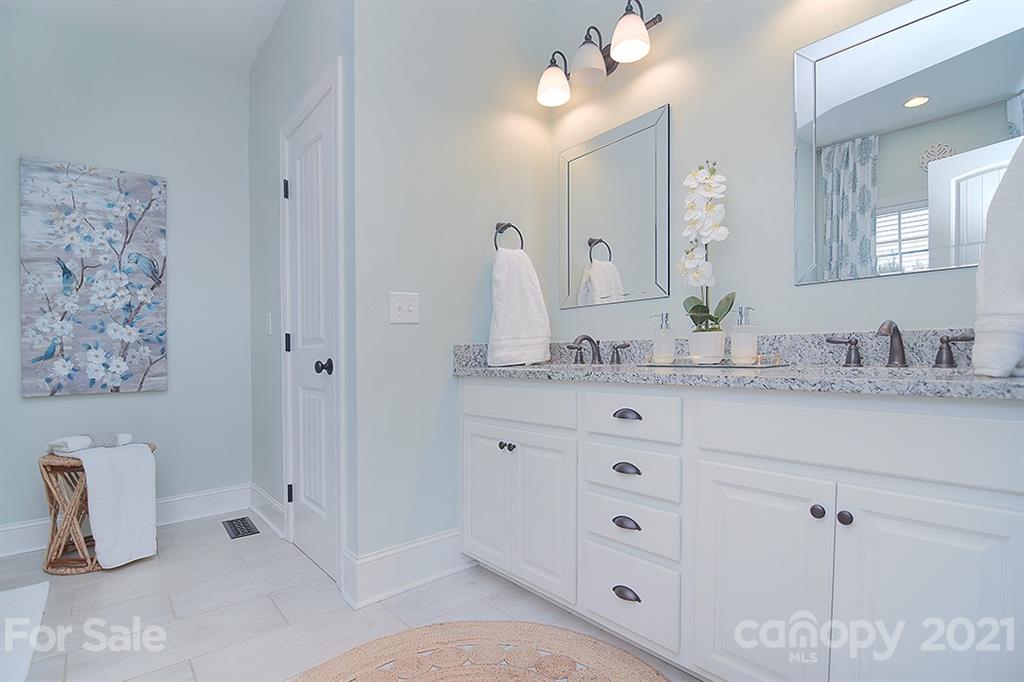 5813 Dudley Road Monroe, NC 28112 - Photo 24 of 44 a bathroom with a granite countertop sink mirror and vanity