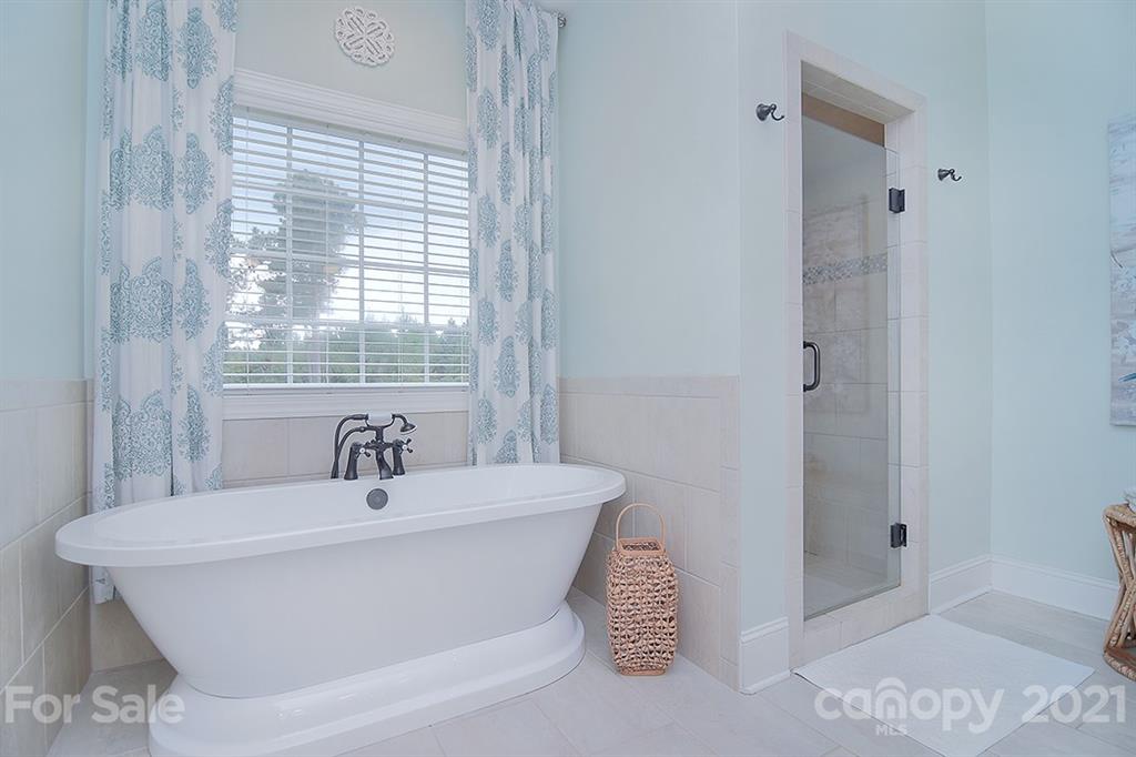 5813 Dudley Road Monroe, NC 28112 - Photo 25 of 44 a bathroom with a white tub shower vanity and a sink
