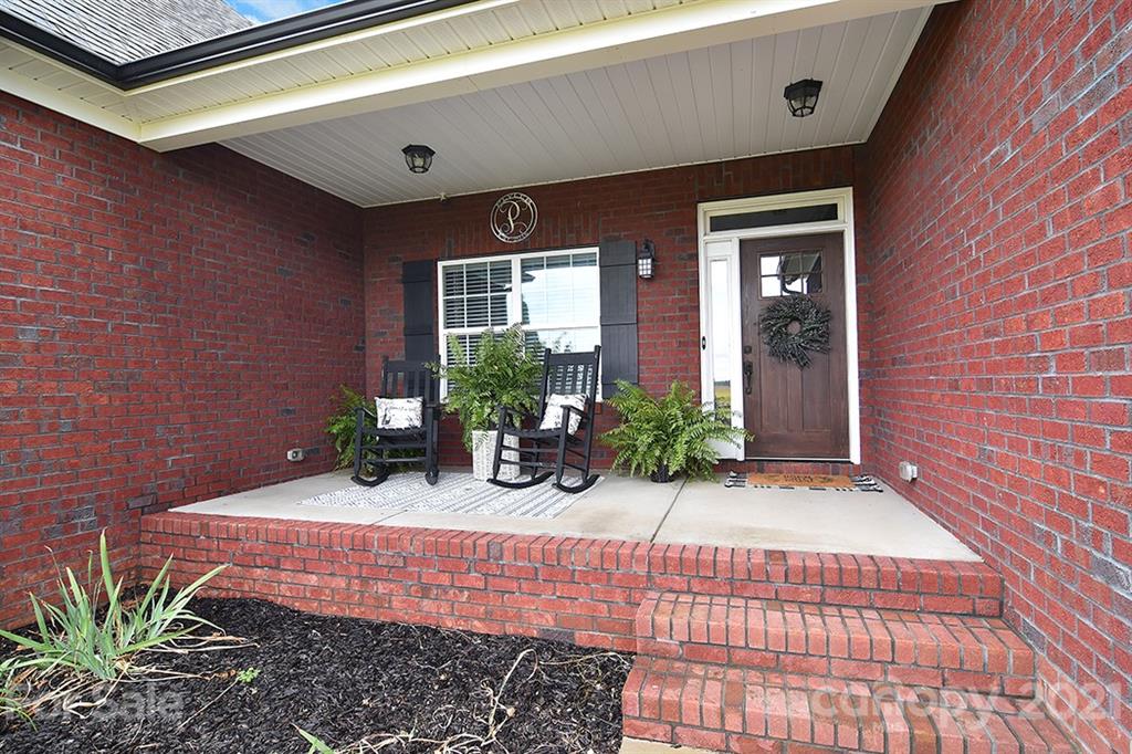 5813 Dudley Road Monroe, NC 28112 - Photo 3 of 44 a view of house with backyard porch and outdoor seating