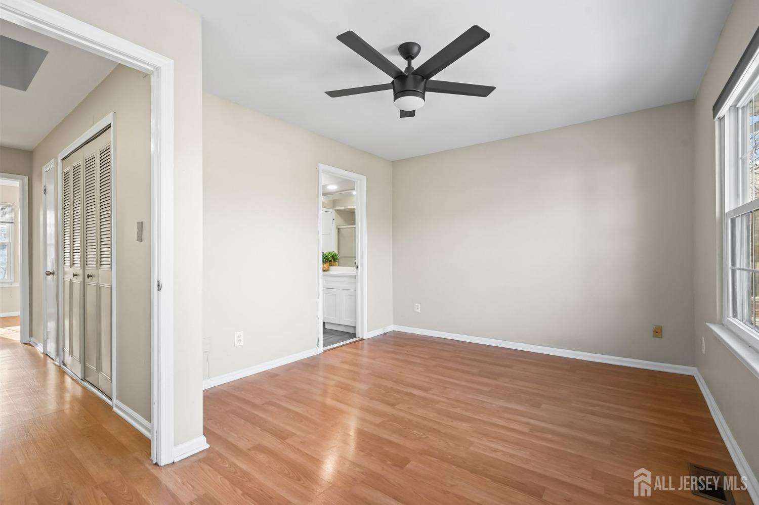 1105 Maplecrest Road Edison, NJ 08820 - Photo 2 of 2 a view of a big room with wooden floor and a ceiling fan