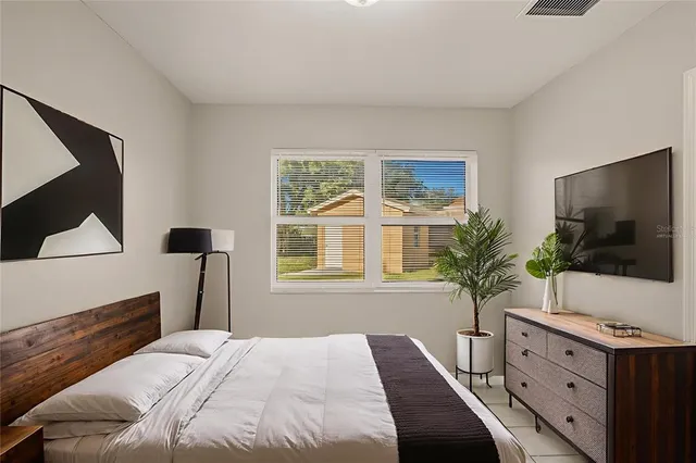 a bedroom with a bed and a flat screen tv
