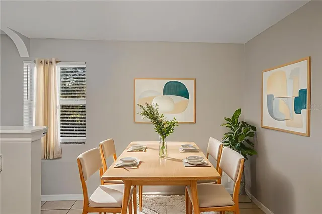 a view of a dining room with furniture and a potted plant