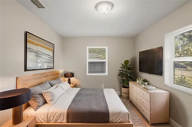 a bedroom with a bed and a flat screen tv