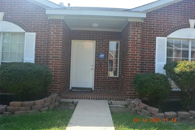 a view of house with backyard