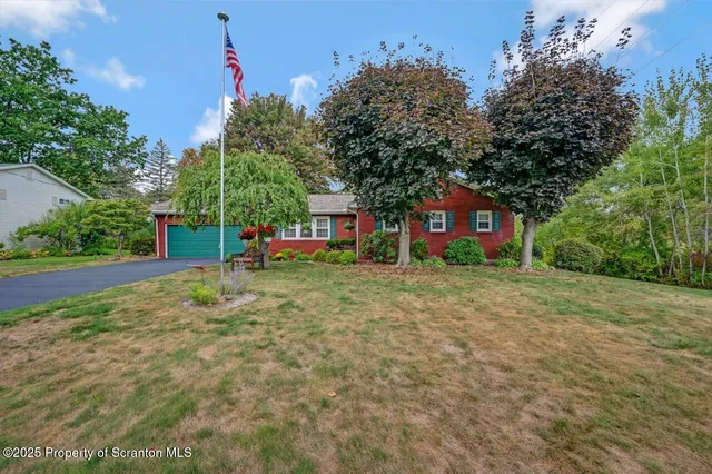 a front view of a house with a yard and a garage