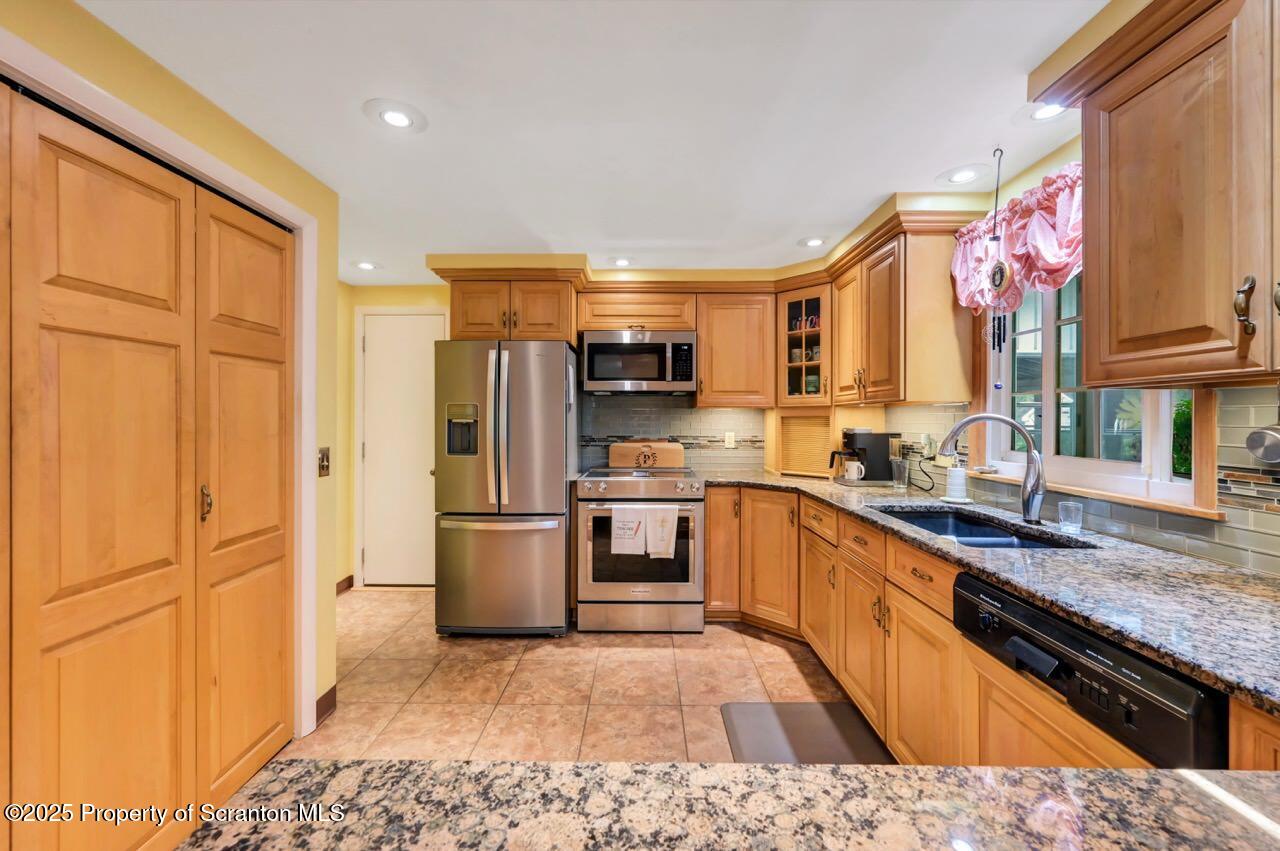 1020 Sleepy Hollow Road Clarks Summit, PA 18411 - Photo 14 of 62 a kitchen with stainless steel appliances granite countertop a refrigerator stove and sink