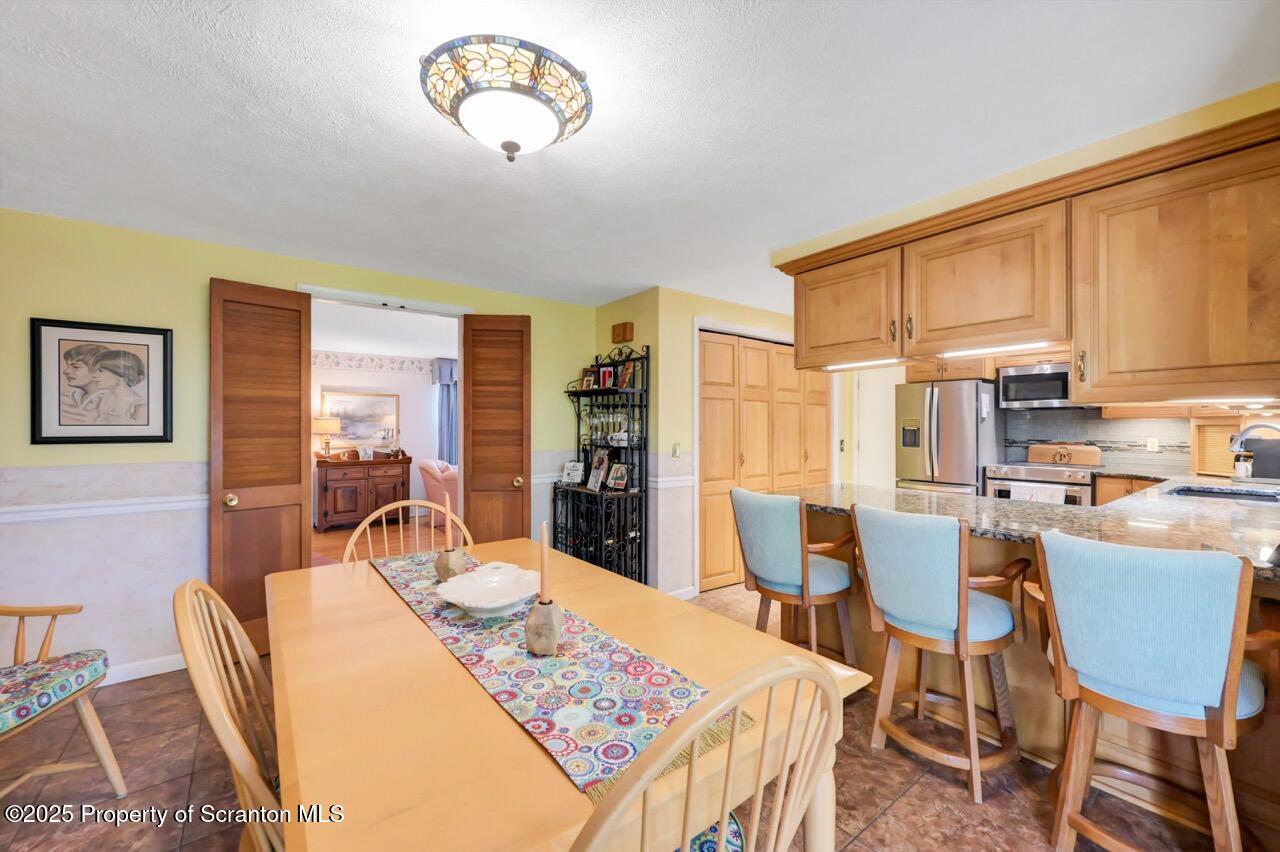 1020 Sleepy Hollow Road Clarks Summit, PA 18411 - Photo 26 of 62 a view of a dining room with furniture window and wooden floor
