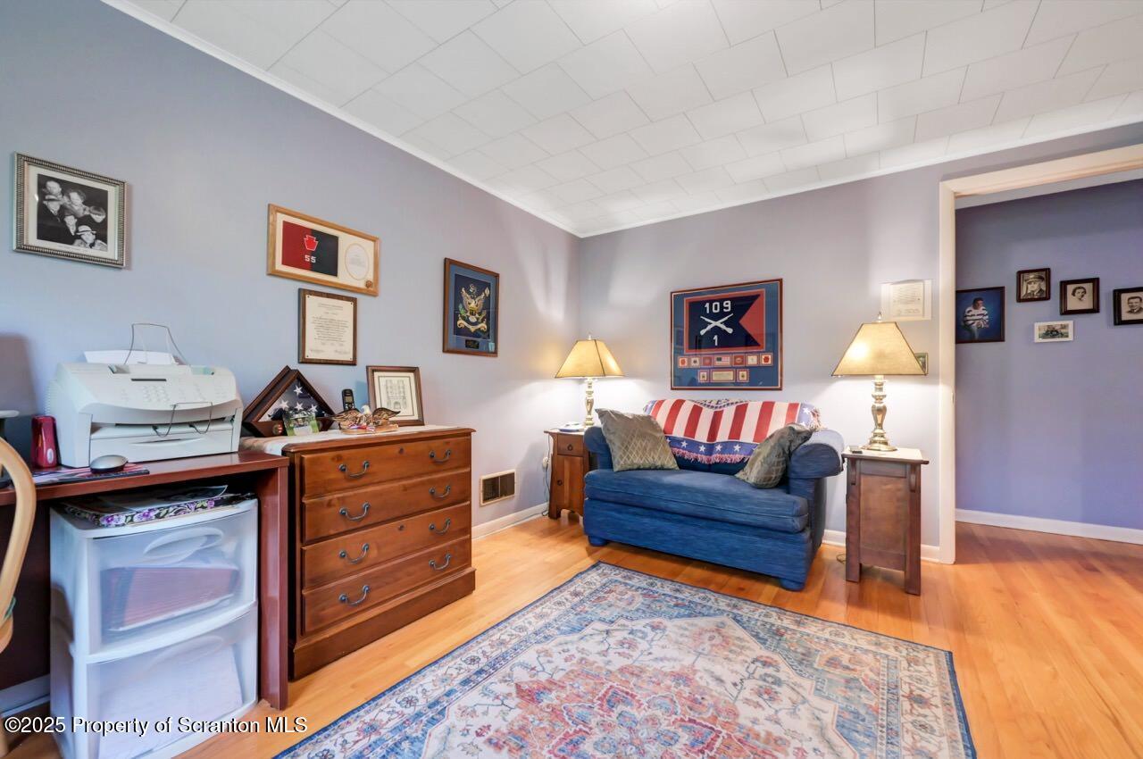 1020 Sleepy Hollow Road Clarks Summit, PA 18411 - Photo 34 of 62 a living room with furniture and paintings on the wall
