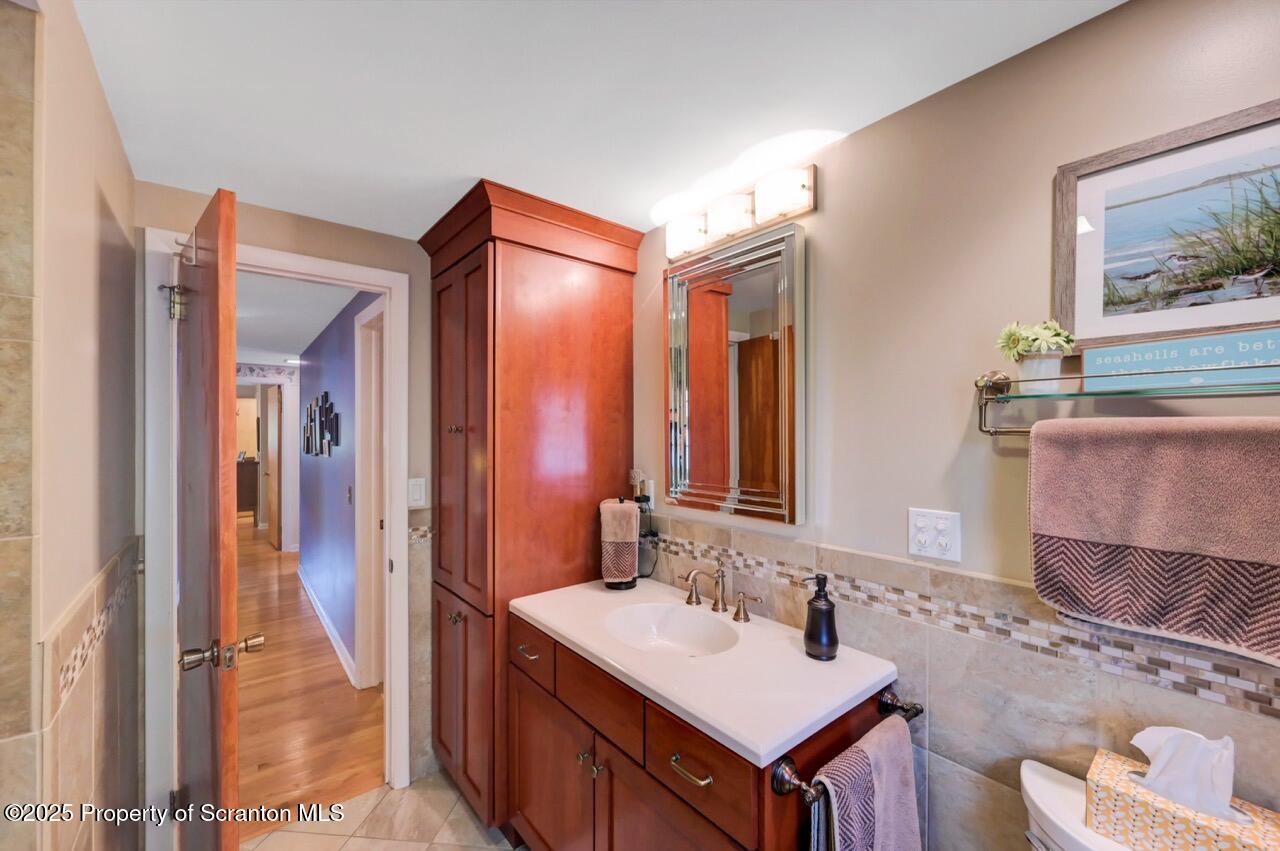 1020 Sleepy Hollow Road Clarks Summit, PA 18411 - Photo 37 of 62 a bathroom with a sink vanity and a mirror