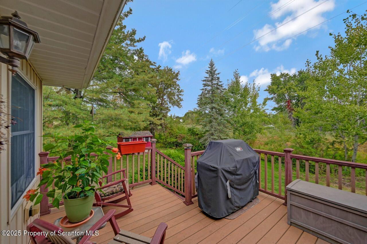 1020 Sleepy Hollow Road Clarks Summit, PA 18411 - Photo 50 of 62 a balcony with wooden floor and outdoor seating