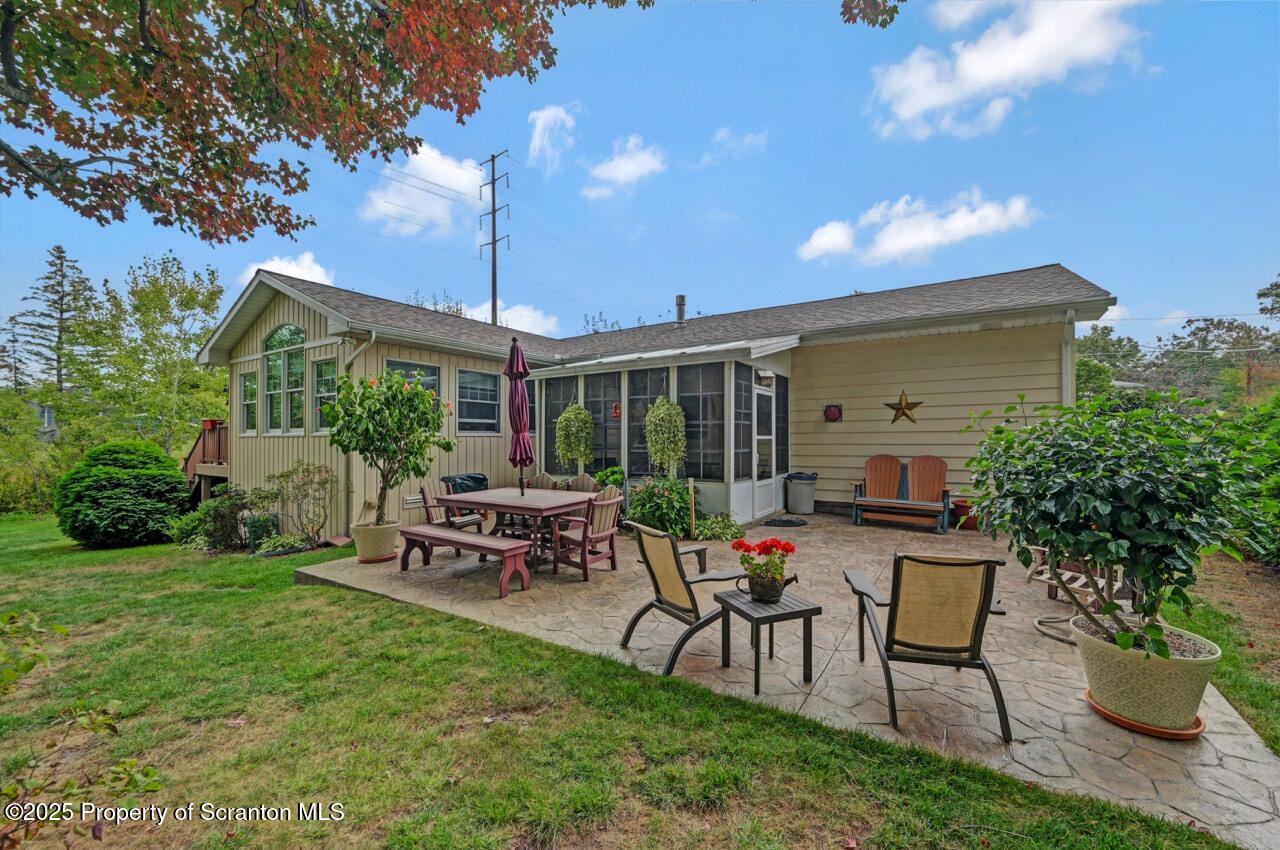 1020 Sleepy Hollow Road Clarks Summit, PA 18411 - Photo 57 of 62 a view of a patio with table and chairs potted plants and a large tree