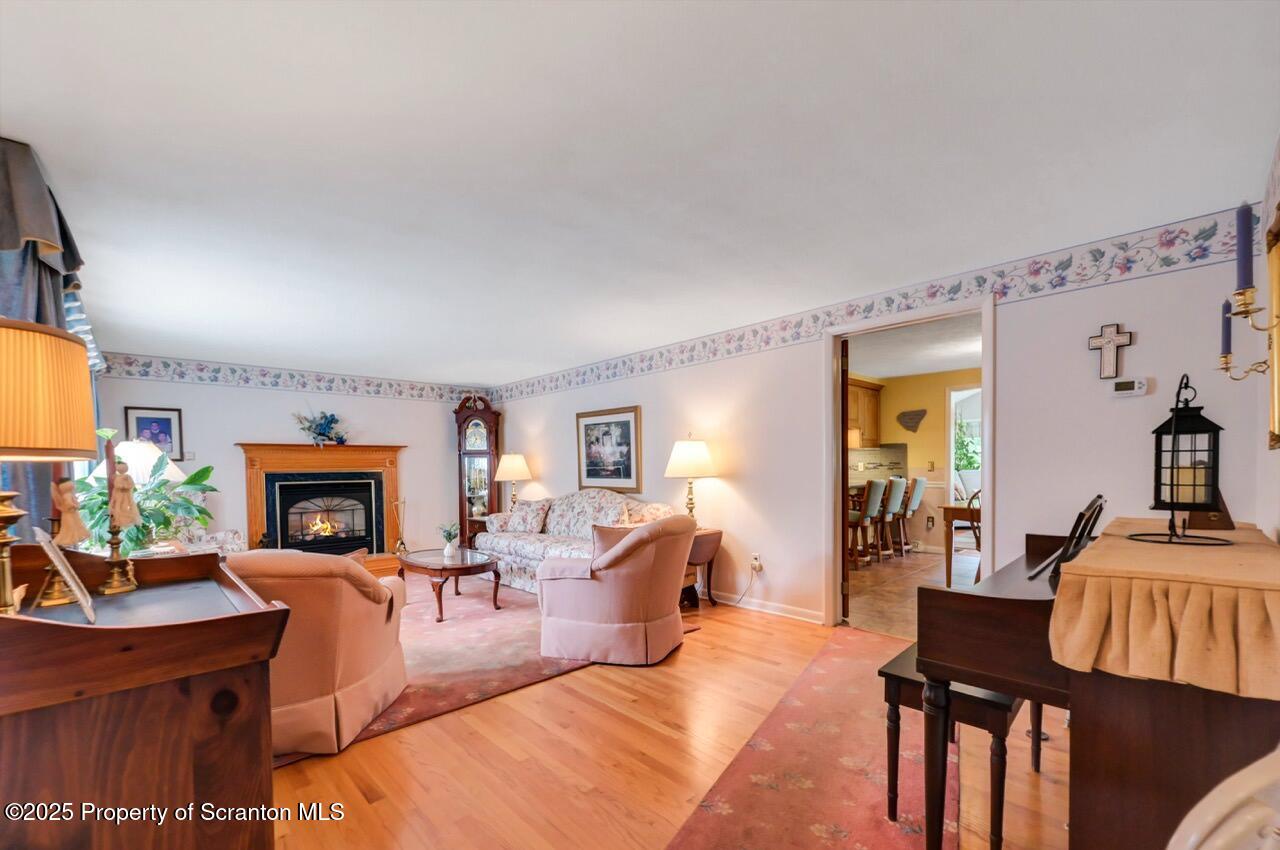 1020 Sleepy Hollow Road Clarks Summit, PA 18411 - Photo 9 of 62 a living room with furniture a fireplace and a potted plant