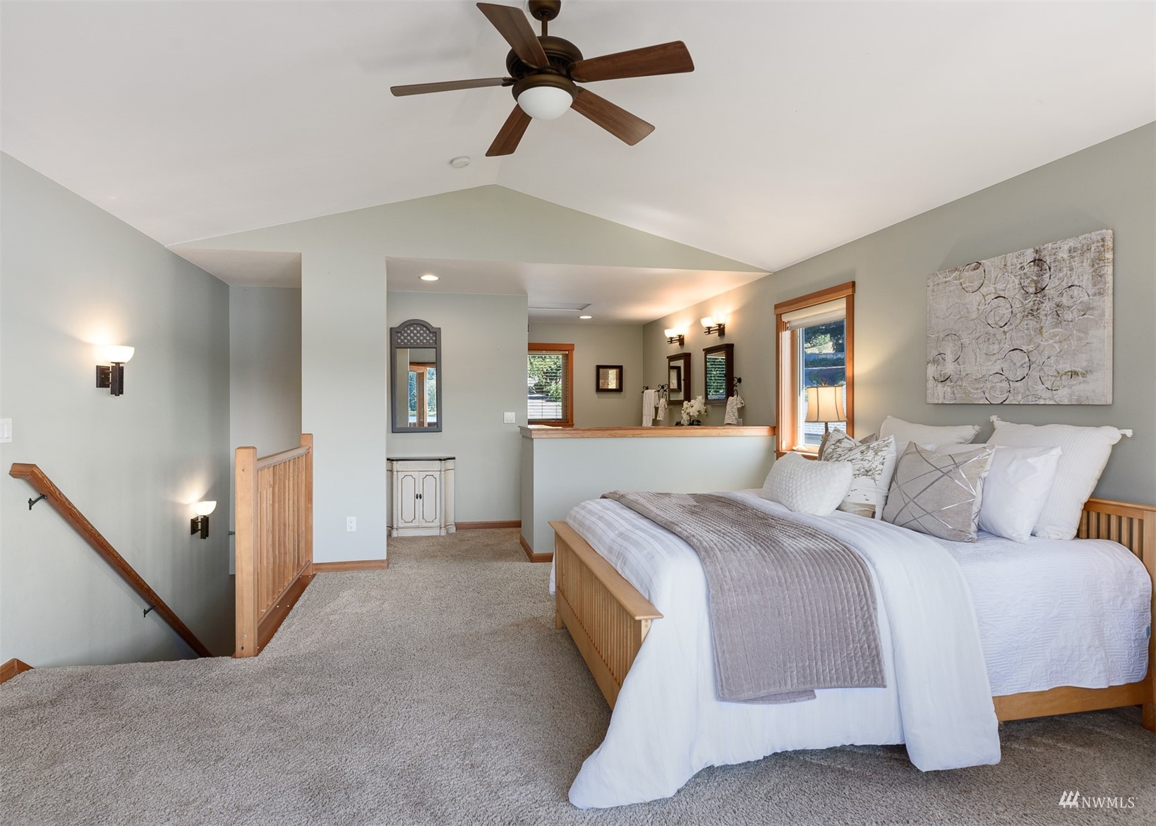 5166 Bayview Road Langley, WA 98260 - Photo 17 of 40 a spacious bedroom with a large bed and a ceiling fan