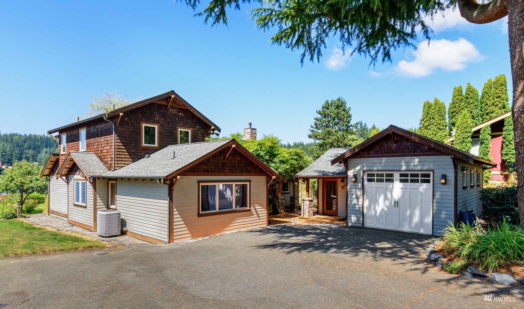 5166 Bayview Road Langley, WA 98260 - Photo 2 of 40 a front view of a house with a yard and garage