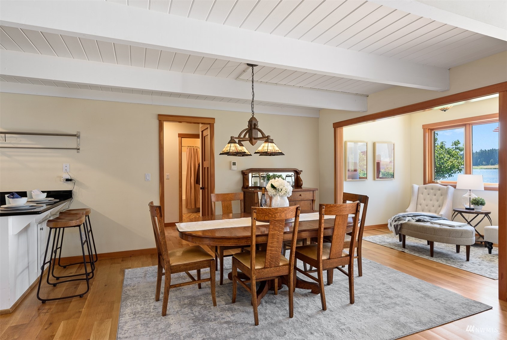 5166 Bayview Road Langley, WA 98260 - Photo 10 of 40 a dining room with furniture window and wooden floor