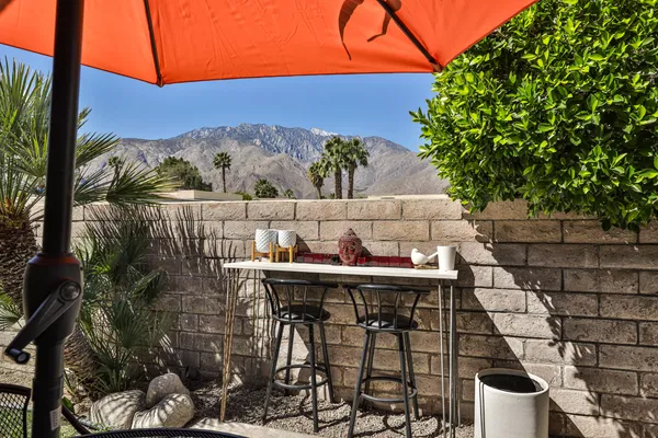 a view of a chairs and table in patio