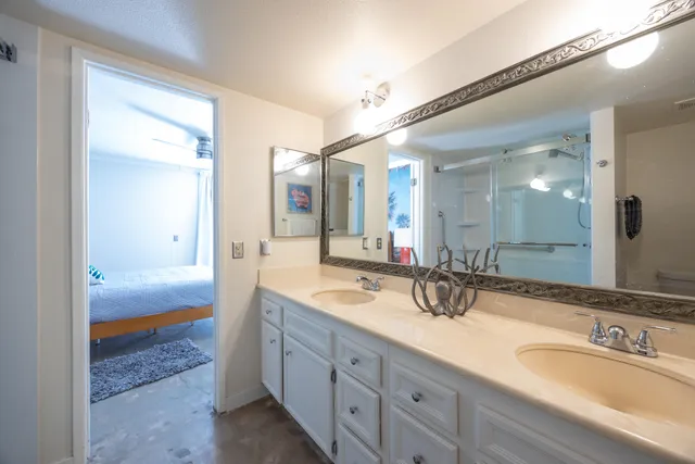 a bathroom with a glass shower door