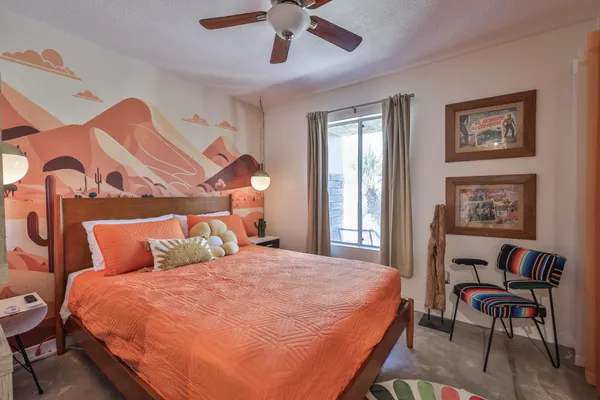 a bedroom with a large bed and a large window