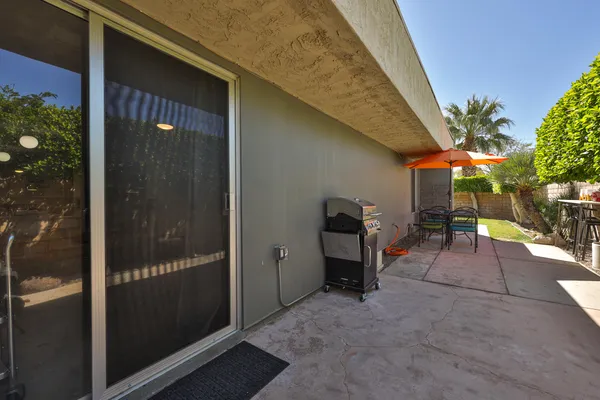 a backyard of a house with table and chairs