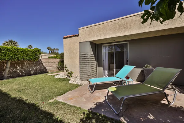 a view of a swimming pool with a lawn chairs and a table