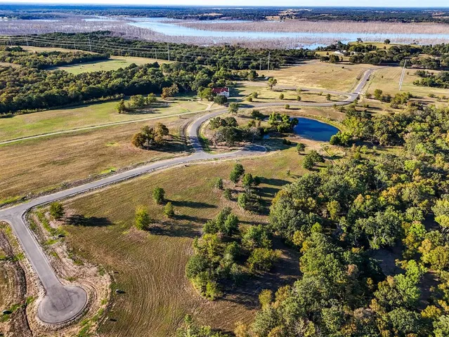 an aerial view of residential houses with outdoor space and swimming pool