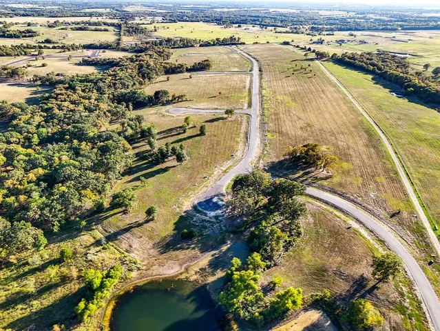 a view of a swimming pool with a lot of people and trees