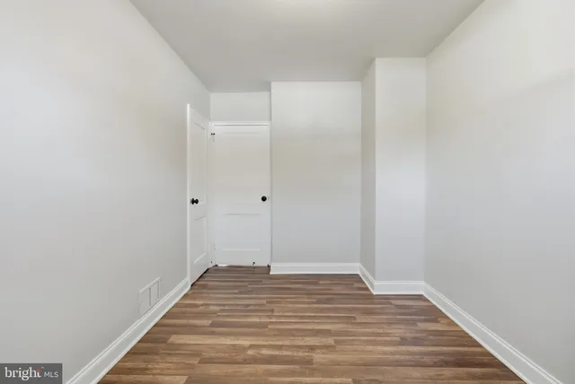 a view of a room with wooden floor