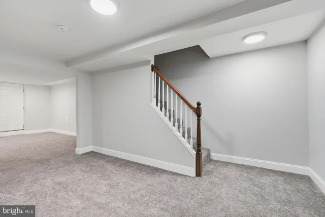 a view of an empty room with stairs