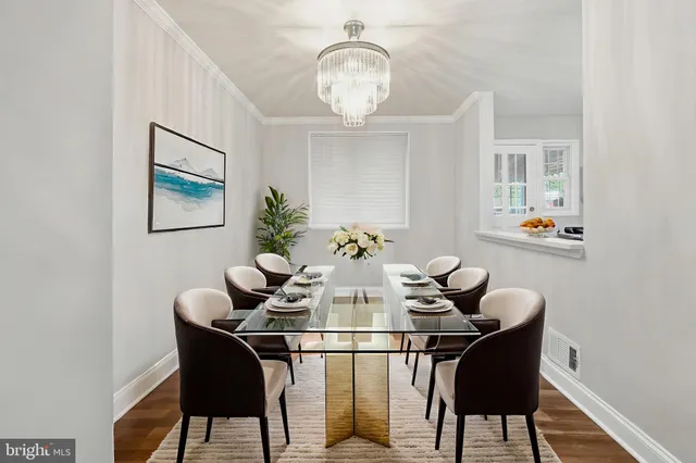 a dining room with furniture and chandelier