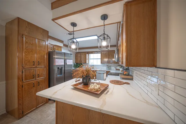 a kitchen with a sink stove top oven and cabinets